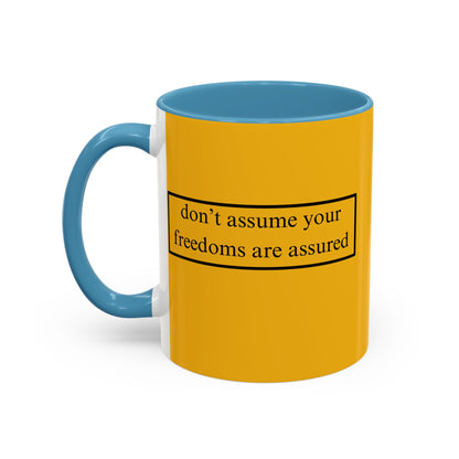 don't assume your freedoms are assured Black font Yellow Accent Mug by theGreenDragonTavern.shop