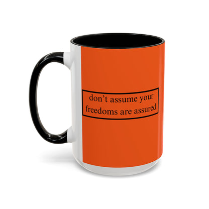 don't assume your freedoms are assured Black font Orange Accent Mug by theGreenDragonTavern.shop
