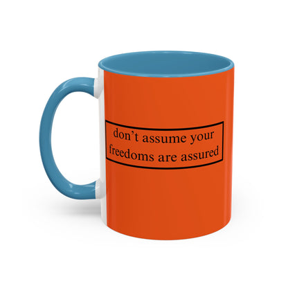 don't assume your freedoms are assured Black font Orange Accent Mug by theGreenDragonTavern.shop