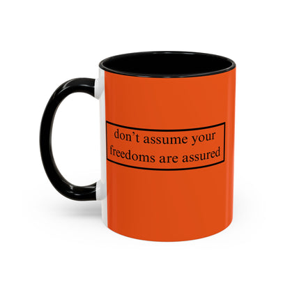 don't assume your freedoms are assured Black font Orange Accent Mug by theGreenDragonTavern.shop