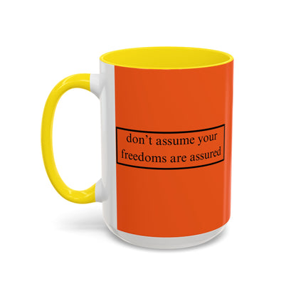 don't assume your freedoms are assured Black font Orange Accent Mug by theGreenDragonTavern.shop