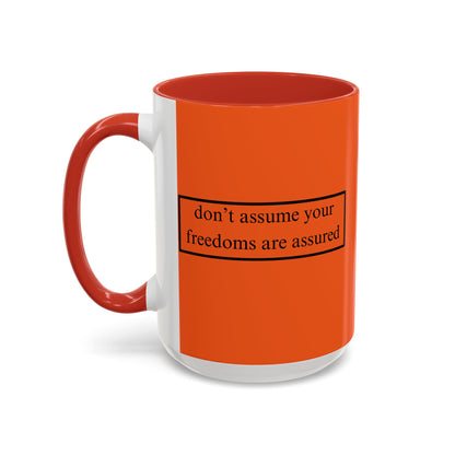 don't assume your freedoms are assured Black font Orange Accent Mug by theGreenDragonTavern.shop