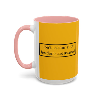 don't assume your freedoms are assured Black font Yellow Accent Mug by theGreenDragonTavern.shop