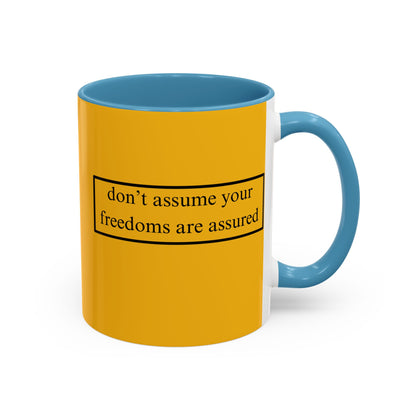 don't assume your freedoms are assured Black font Yellow Accent Mug by theGreenDragonTavern.shop