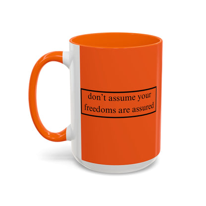 don't assume your freedoms are assured Black font Orange Accent Mug by theGreenDragonTavern.shop