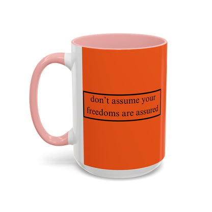 don't assume your freedoms are assured Black font Orange Accent Mug by theGreenDragonTavern.shop