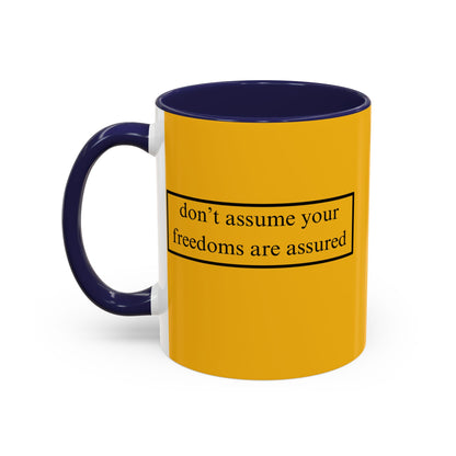don't assume your freedoms are assured Black font Yellow Accent Mug by theGreenDragonTavern.shop