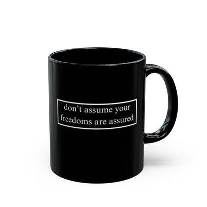 don't assume your freedoms are assured White font Black Mug by theGreenDragonTavern.shop