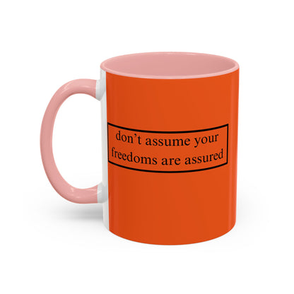 don't assume your freedoms are assured Black font Orange Accent Mug by theGreenDragonTavern.shop