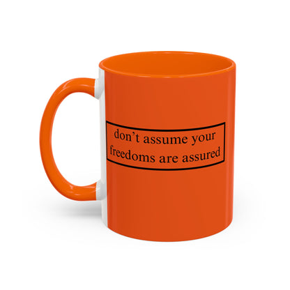 don't assume your freedoms are assured Black font Orange Accent Mug by theGreenDragonTavern.shop
