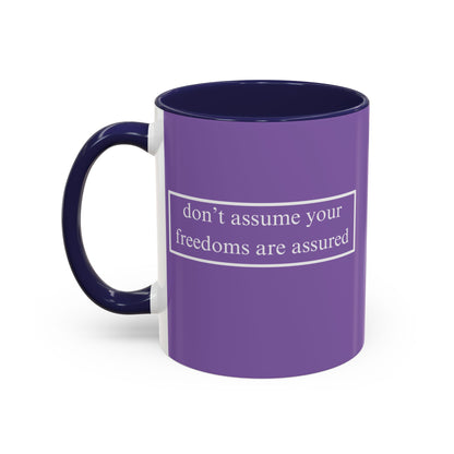 don't assume your freedoms are assured White font Light Purple Accent Mug by theGreenDragonTavern.shop