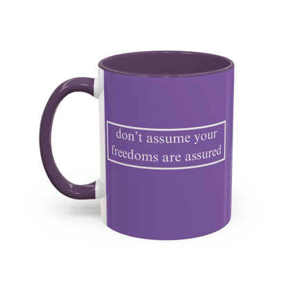 don't assume your freedoms are assured White font Light Purple Accent Mug by theGreenDragonTavern.shop