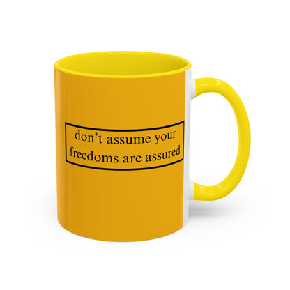 don't assume your freedoms are assured Black font Yellow Accent Mug by theGreenDragonTavern.shop