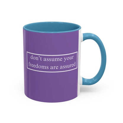 don't assume your freedoms are assured White font Light Purple Accent Mug by theGreenDragonTavern.shop