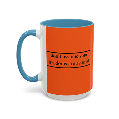 don't assume your freedoms are assured Black font Orange Accent Mug by theGreenDragonTavern.shop